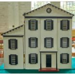 A painted wooden doll's house, mid 20th c, grey roof, white painted with black framed windows and