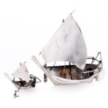 A South East Asian silver model of a boat and a similar smaller model, 20th c, unmarked, 2ozs 10dwts