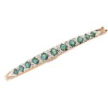 A 9ct gold diamond and emerald bangle, 9.9g