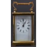 A French brass carriage timepiece, early 20th c, with enamel dial, 11cm h excluding handle Working