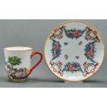 A German porcelain chocolate cup and saucer, early 20th c, moulded in relief and enamelled and