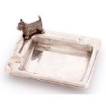 A George VI silver ashtray, the rim set with terrier, 80mm l, by J B Chatterley and Sons Limited,