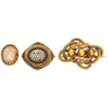 A cameo brooch, in gold and two Victorian giltmetal brooches, various sizes (3) Some faults