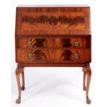 A mahogany bureau, c1930, the sliding interior with pair of EPNS capped glass inkwells, on