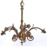 A brass chandelier, early 20th c, of five lights, the baluster and globe shaft with six arched