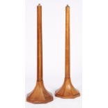 A pair of art deco stained walnut standard lamps, mid 20th c, the tapered octagonal shaft on