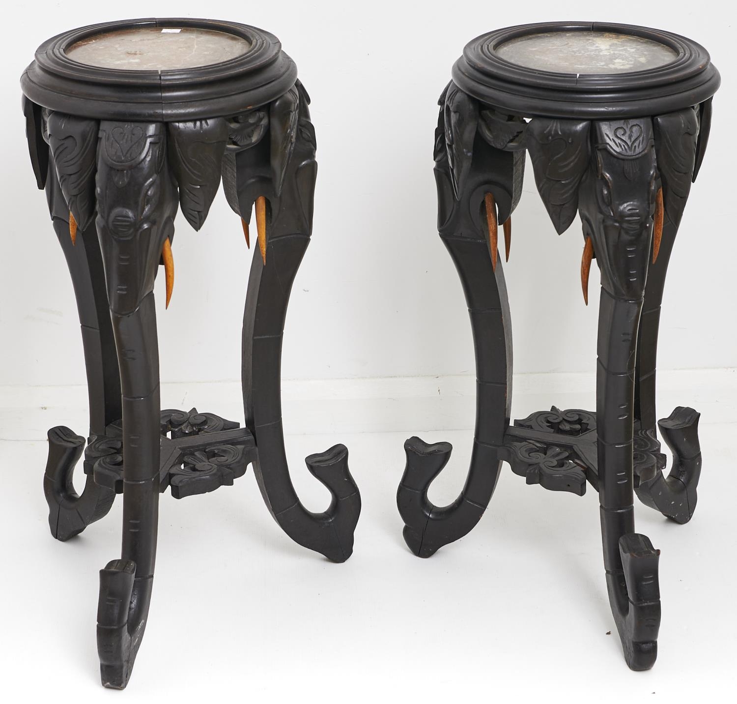 A pair of oriental marble topped ebonised jardinere stands, early 20th c, the circular tops above