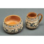 A Doulton ware cream jug and sugar bowl,  by Francis E Leigh, decorated with white flowerheads and