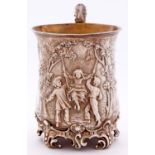 A Victorian silver christening mug, of baluster form, embossed with three children playing on a