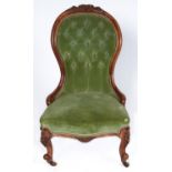 A Victorian walnut nursing chair, c1870, the top rail carved with flowerheads and leafage on a
