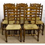 Eight stained ash ladder back chairs, early 20th c, rush seated, seat heights 45cm and circa