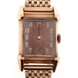 A mid century Bulova gold plated rectangular gentleman's wristwatch, with pink dial, later