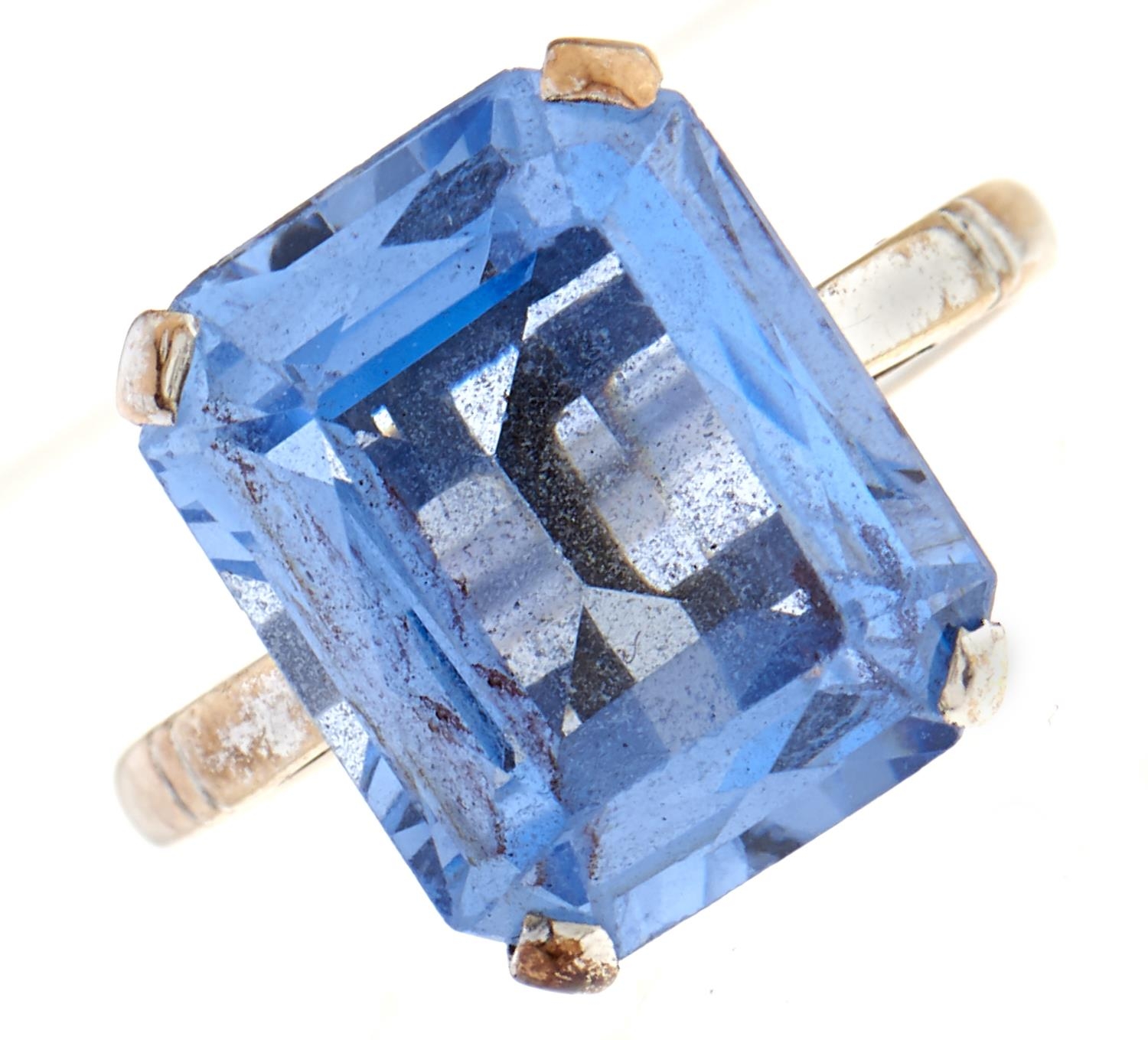 A blue paste ring, in white gold marked 9ct, 3.8g, size L Very slight scratches on facets when
