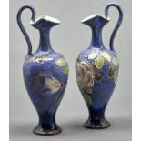 A pair of Doulton ware lavender blue ground tube lined rose ewers, c1920, 30cm h, impressed marks,