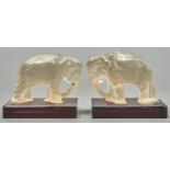 A pair of Czechoslovakian frosted glass elephant bookends on amethyst glass base, c1930, 11cm h