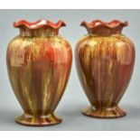 A pair of Linthorpe art pottery vases, c1885, with frilled neck and spreading foot, covered in a