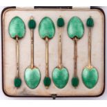 A set of six Edward VIII silver gilt and apple green guilloche enamel coffee spoons, bean