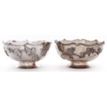 A pair of Chinese silver bowls, early 20th c, applied with repousse birds and blossoming bands, on