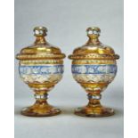 A pair of Bohemian cut and blue and amber flashed glass sweetmeat jars and covers, early 20th c, the