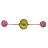 A peridot and pink sapphire bar brooch, in gold, 4g