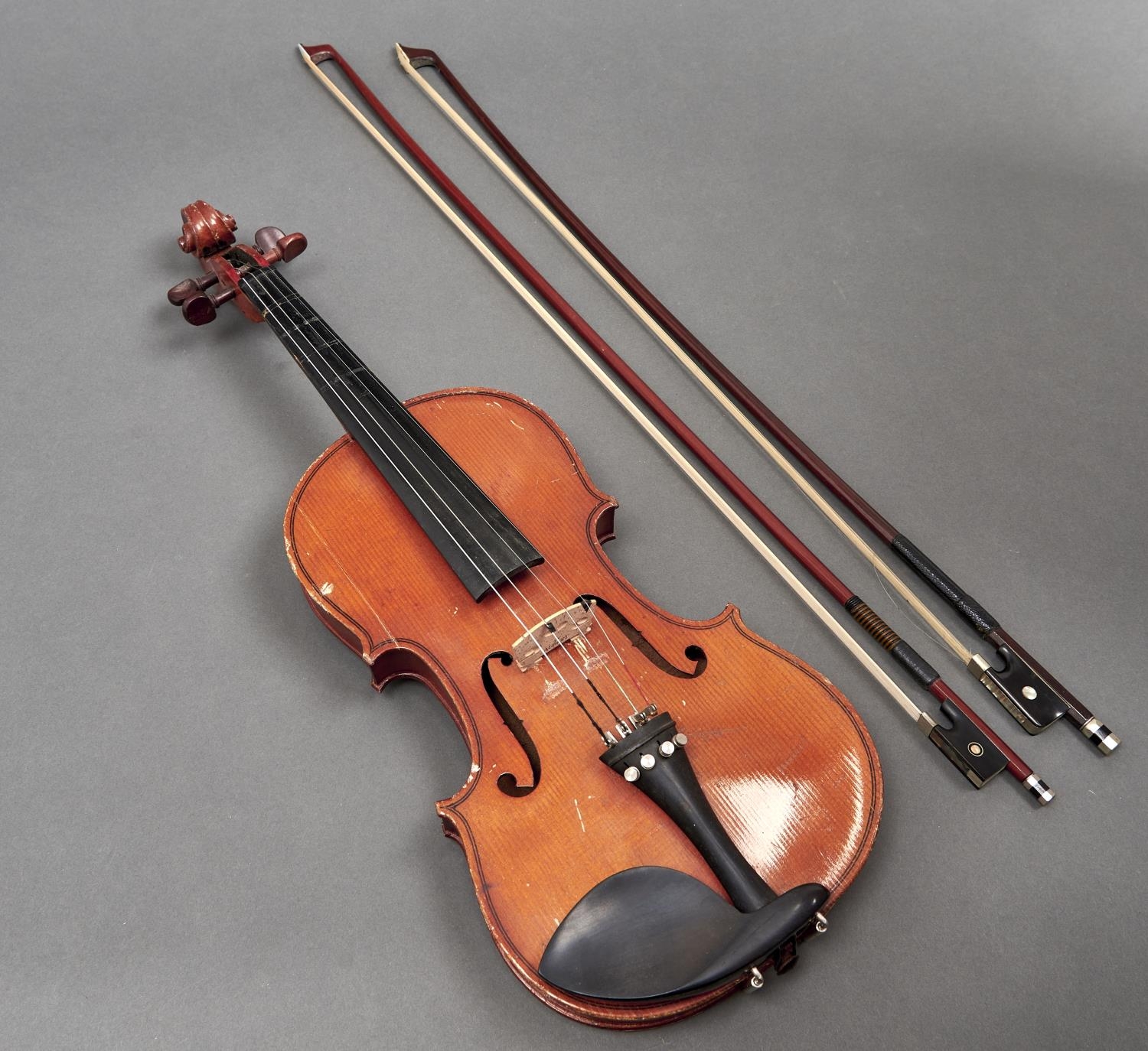 A violin,  unlabelled, length of back 35.5cm and two violin bows Violin - table cracked, back