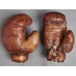 Boxing. An antique pair of leather boxing gloves, early 20th c In overall very good condition, no