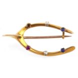 A ruby, sapphire and diamond wishbone brooch, in gold, one stone deficient, 4.3g,