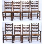 A set of eight ash ladder back dining chairs with graduated wavy horizontal rails, rush seats on