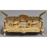 A brass inkwell of Celtic design, late 19th/early 20th c, the back with cast back centred on a