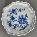 An English Delftware tray, c1760, of cushion shape with scalloped border, painted in cobalt with a