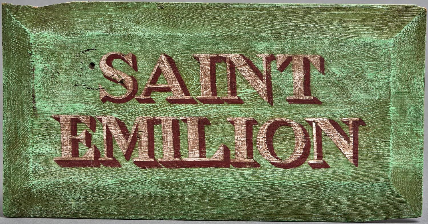 A decorative painted wood name board - Saint Emilion, 20th c, chamfered edges, 30 x 59cm Two corners