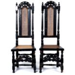 A pair of Queen Anne walnut high back caned chairs, c1700, with pierced arched cresting rails