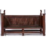 A French oak settle, 19th c, in late medieval style, with lion finials and carved panels to the back