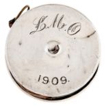 An Edwardian silver tape measure, 35mm diam, Birmingham 1909 Dented and worn