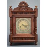 A Victorian oak cased mantel clock, c1890, with arched pediment and bun shaped lacquered brass