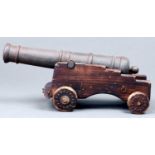 An iron model 1812 cannon on stained wood carriage, 20th c, barrel 36cm l