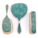 A George V three piece silver gilt and shagreen brush set, hand mirror 24cm l, by William Comyns and