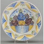 A Dutch polychrome Delftware dish, c1770, painted in cobalt, green, manganese and yellow with