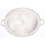 A George V oval silver tea tray with fluted border, 71cm over handles by Stevenson & Law,