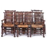 A set of eleven early Victorian rush seated ash spindle back dining chairs, including two elbow