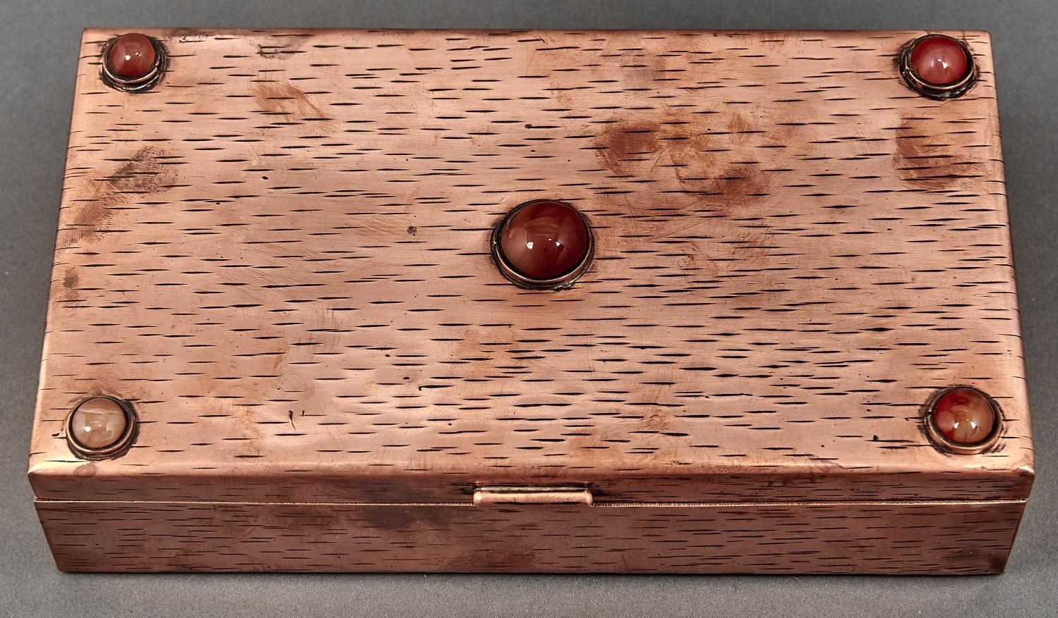 An arts and crafts copper box, the lid set with five cornelians en cabochon, early 20th c, 23cm l