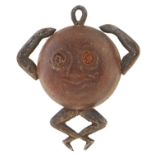 A WWI wood and metal Fumsup Touch Wood charm