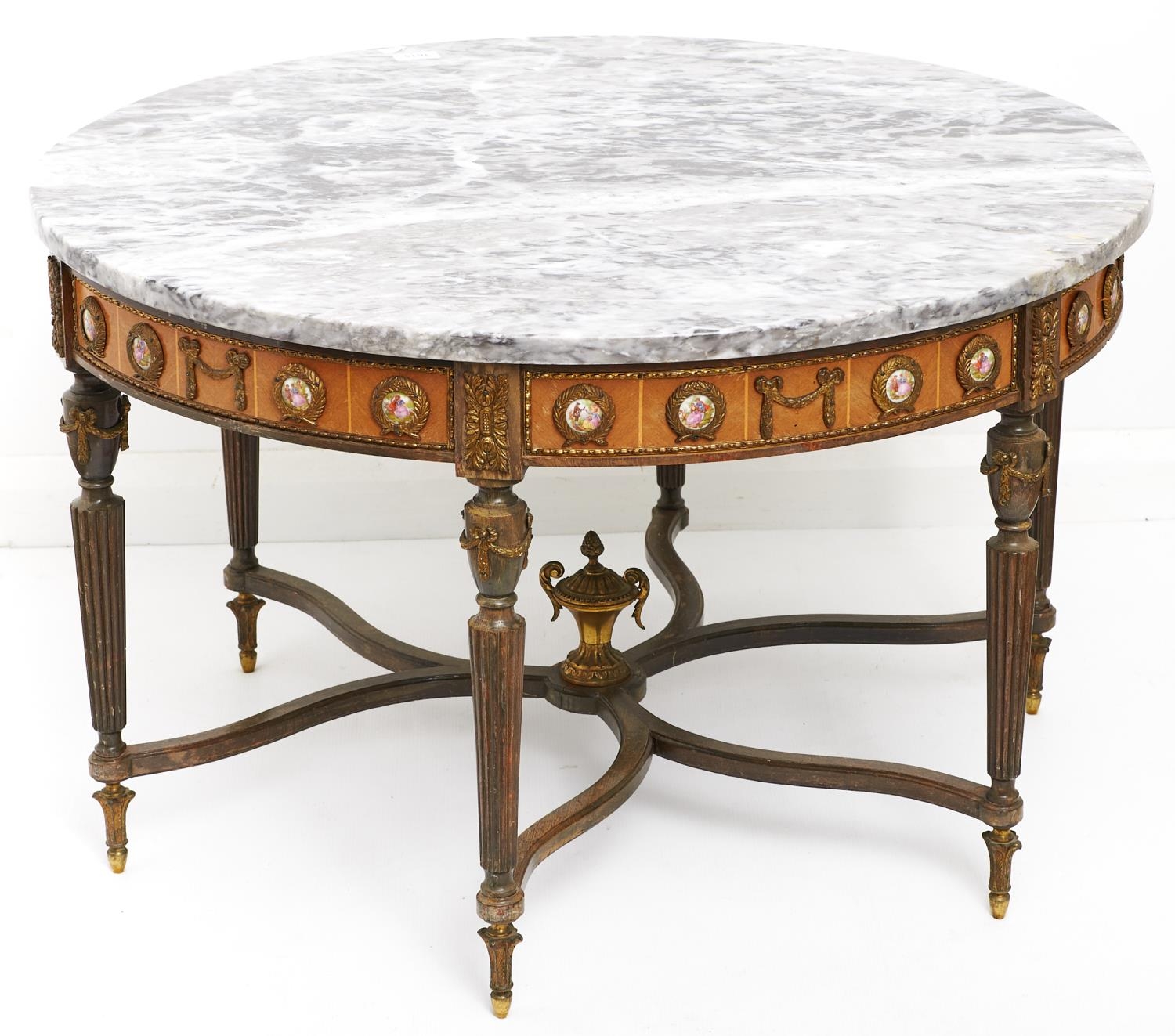 A giltmetal mounted mahogany-stained low round table, with marble slab, the frieze applied with