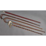 Five silver mounted and other walking canes and sticks, all c1900, three of bamboo, two with