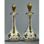 A pair of cased glass scent bottles and stoppers, mid 19th c, of green glass cased in white,