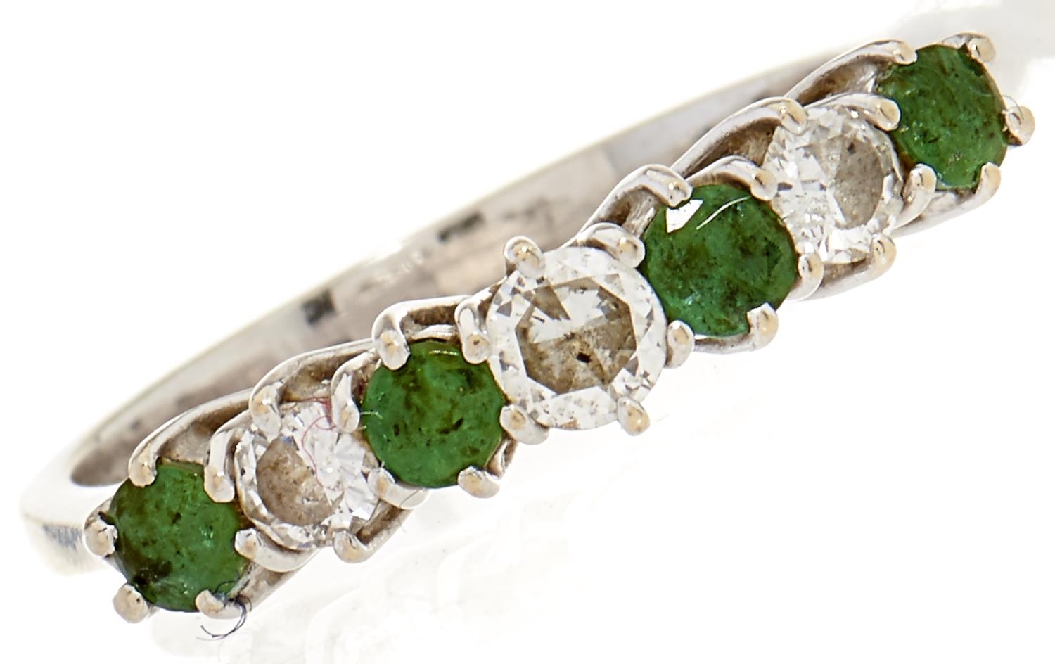 A seven stone emerald and diamond ring, diam wt 0.22ct, emerald wt 0.6ct, in white gold marked