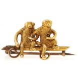 A gold brooch of two monkeys, marked 15ct, 3.4g