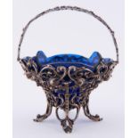 A Victorian cast silver sugar basket, of ogee shape with swing handle and decorated with festoons of