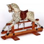 A painted wood rocking horse, mid 20th c, with leather saddle, bridle and reins, on waxed pine
