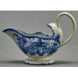 A pearlware sauceboat, c1790, painted to each side with a temple and fence flanked by flower and